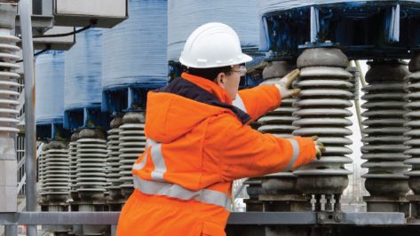 A Powertech worker prepares high power insulators for testing.